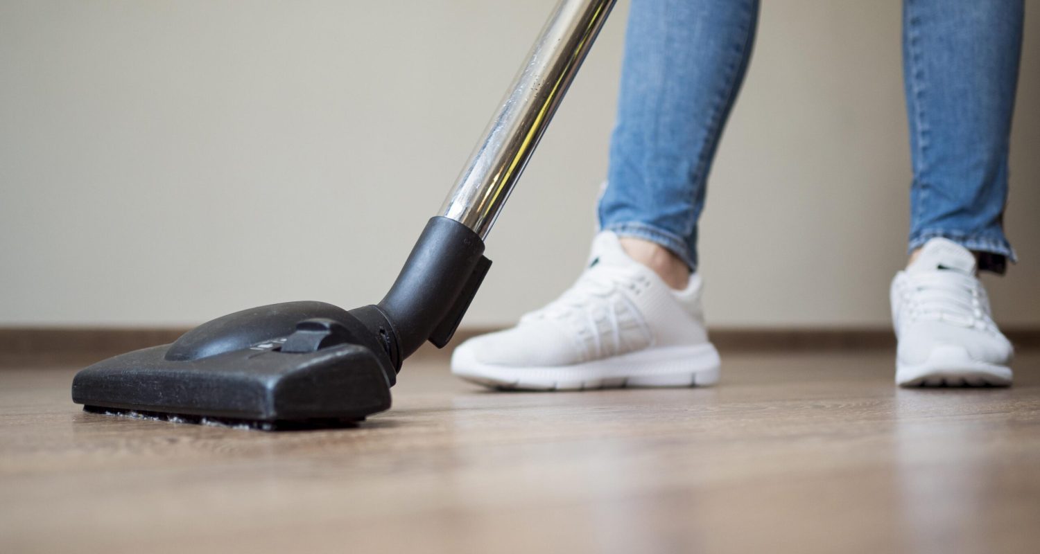 close-up-individual-using-vacuum-cleaner